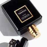 Close-up of Chanel Coco Noir Eau de Parfum 100ml showing gold spray nozzle and elegant black cap, highlighting premium perfume design.