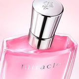 Close-up of Lancome Miracle Eau de Parfum 100ml showing silver cap with rose engraving and elegant pink liquid, ideal for a floral fragrance lover.