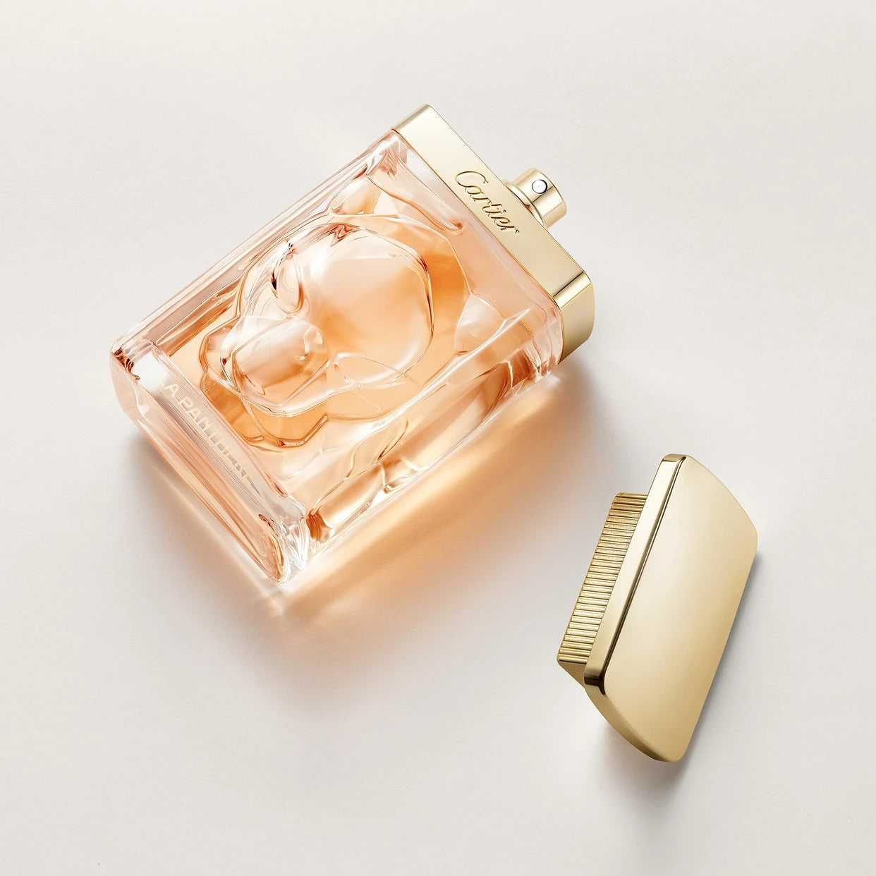 La Panthère Eau de Parfum - 75ml Sensual Floral Chypre Perfume lying flat with gold cap removed, highlighting the intricate bottle design.