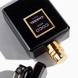 Close-up of Chanel Coco Noir Eau de Parfum 100ml showing gold spray nozzle and elegant black cap, highlighting premium perfume design.
