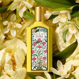Gucci Flora Gorgeous Orchid Eau de Parfum 100ml surrounded by blooming white orchids, highlighting its exotic floral essence.