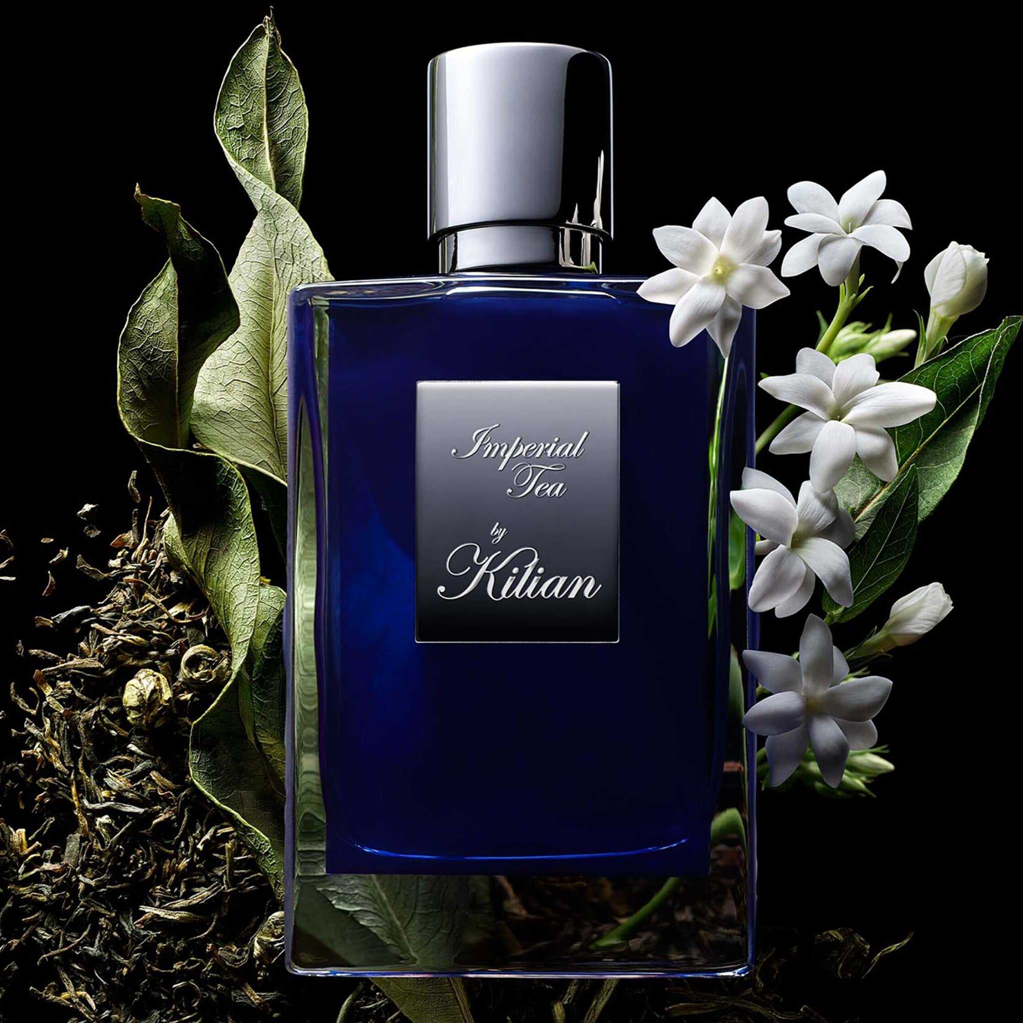 Imperial Tea by Kilian – Eau de Parfum (50ml) bottle surrounded by jasmine flowers and green tea leaves, reflecting its fresh and aromatic scent profile.