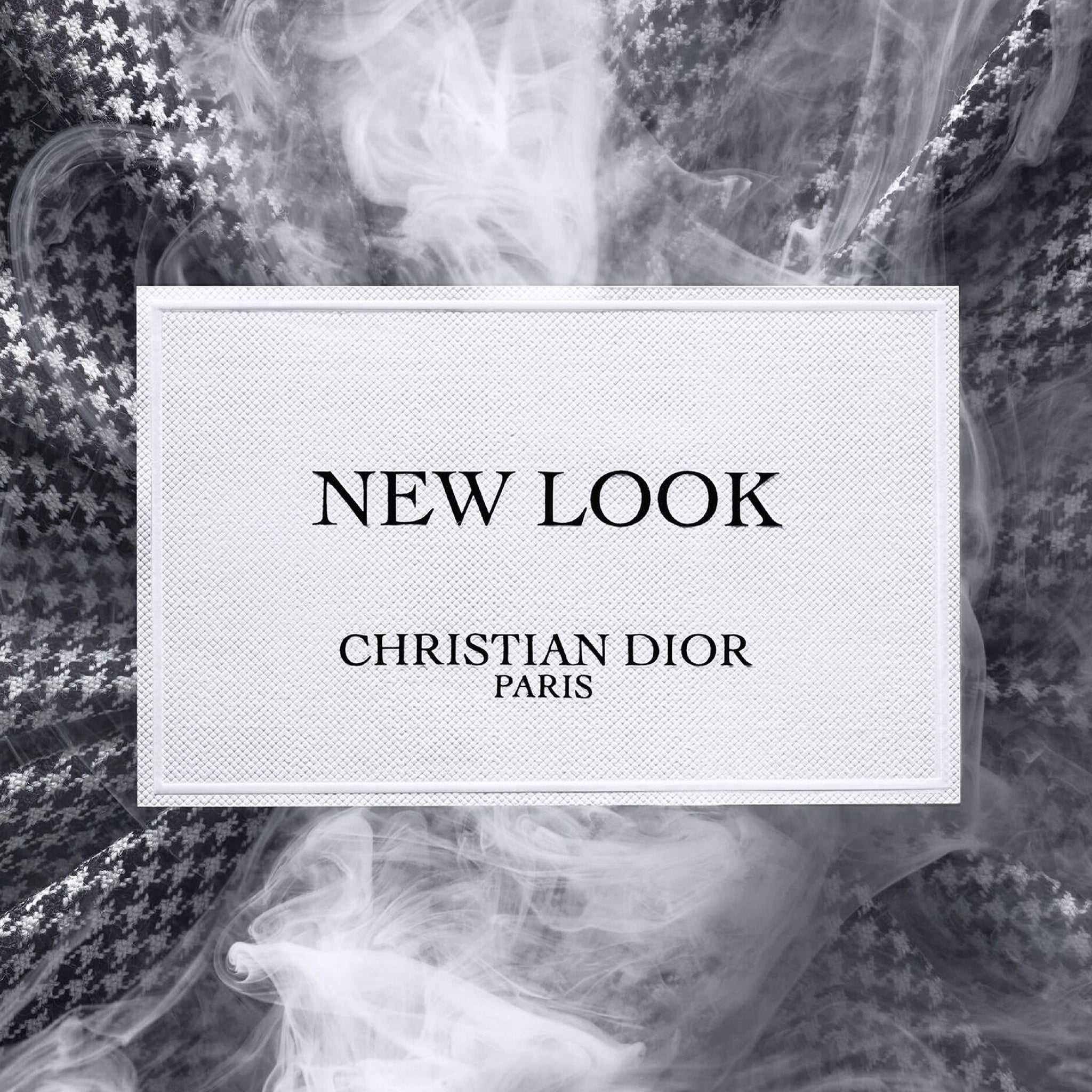 Label of New Look by Dior – Modern Floral Amber Eau de Parfum set against smoky houndstooth fabric, highlighting the elegant branding.