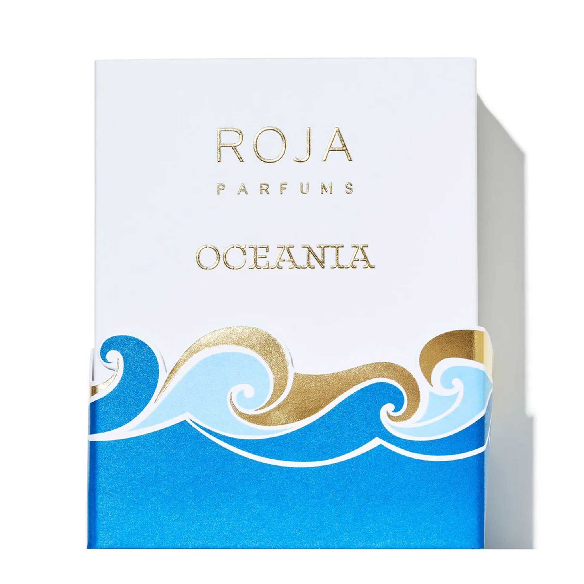 Elegant white and blue packaging of Roja Parfums Oceania – Extrait de Parfum (100ml) featuring gold embossed branding and wave design.