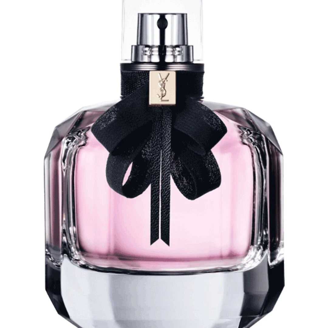 Close-up of YSL Mon Paris Eau de Parfum 90ml bottle with elegant black ribbon and pink liquid, symbolizing romantic floral elegance.